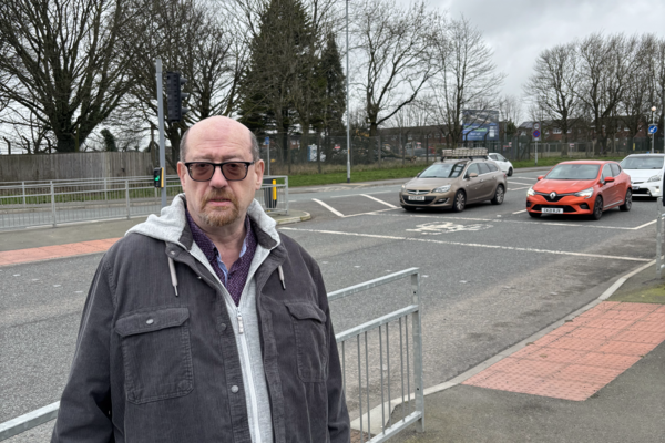 Iain Donaldson with the development site behind him.