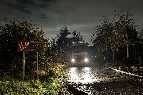 A truck approaches at night.